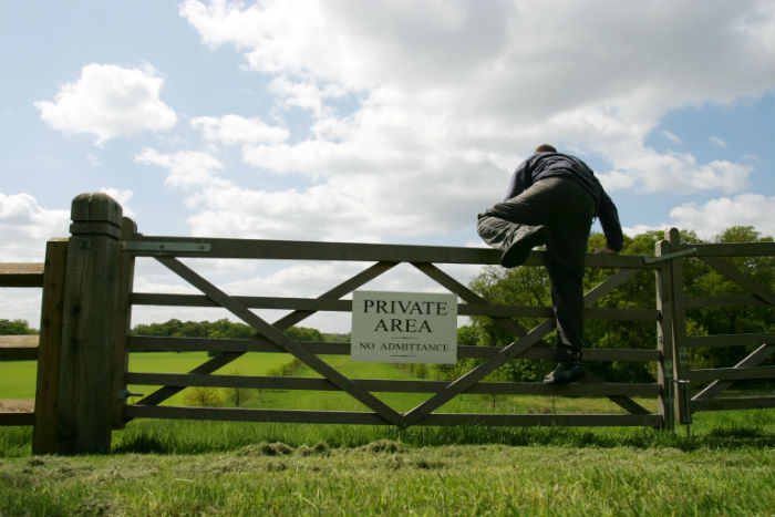 farm-gate-man-climbing-over-private